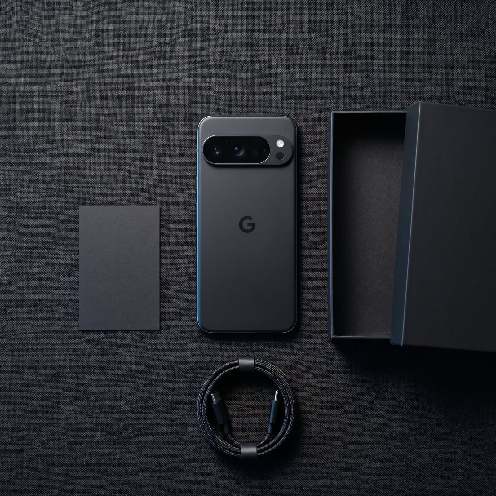 The Privacy Phone with its box and cable, laid out on a dark surface